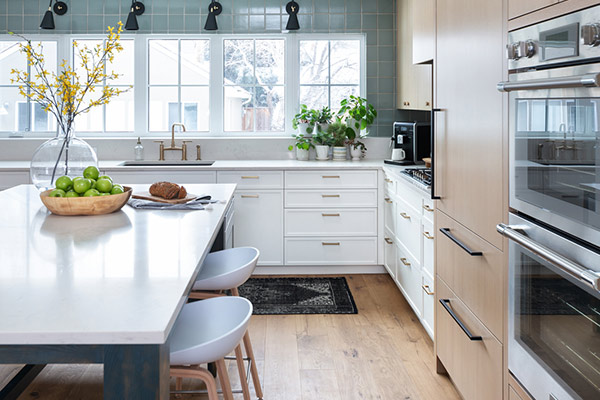 Modern kitchen featuring a large island, high-end appliances, complemented by sleek cabinetry in stunning custom home.